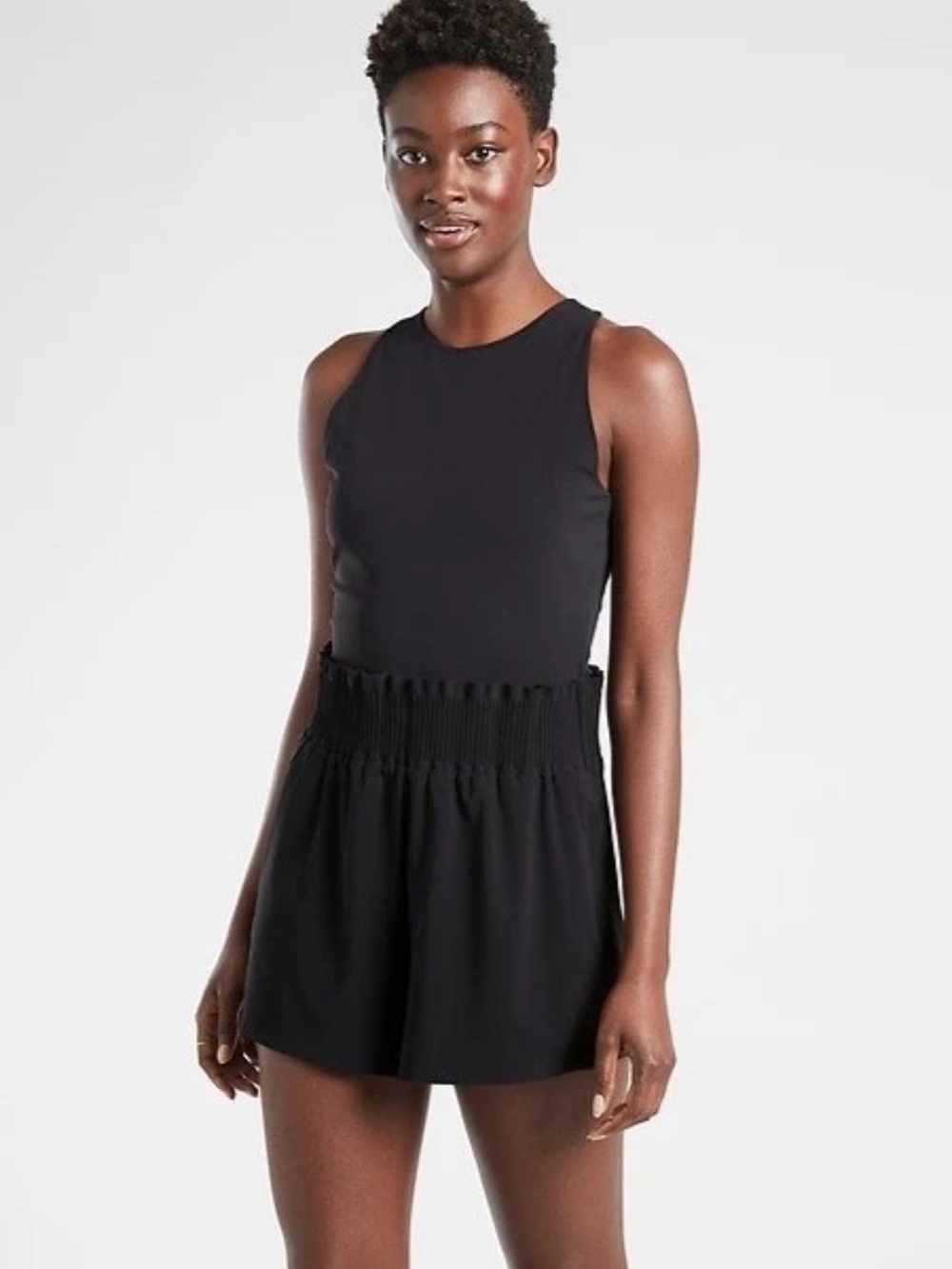 black Athleta romper featuring a high neckline, a zippered back